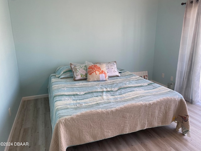 bedroom with wood-type flooring