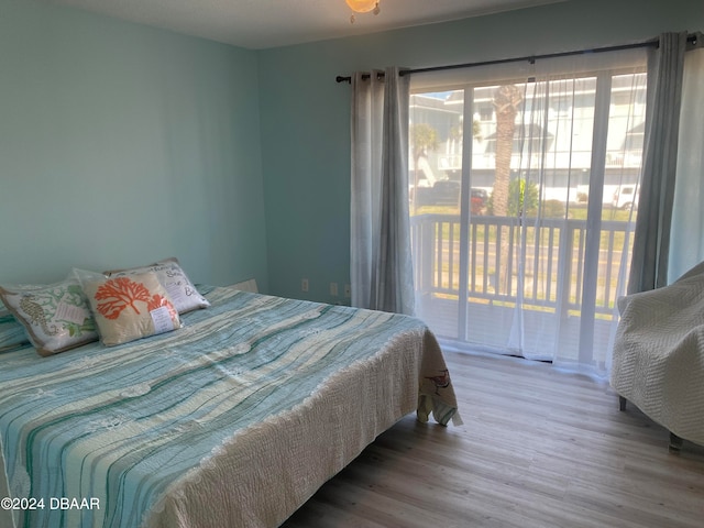 bedroom featuring hardwood / wood-style floors and access to exterior