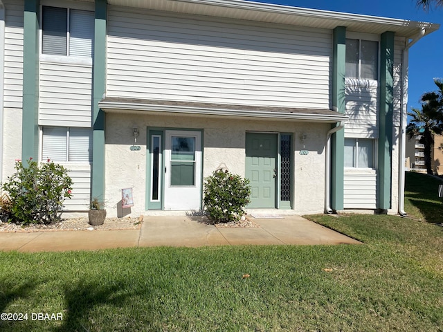 rear view of property with a yard