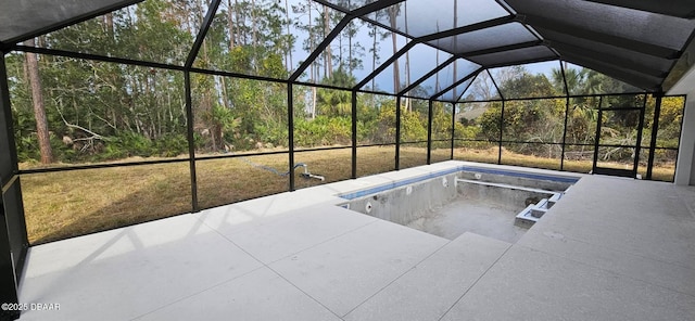 view of pool with glass enclosure and a patio area