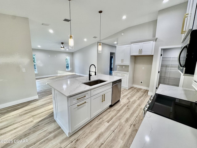 kitchen with a sink, white cabinets, stainless steel dishwasher, a center island with sink, and pendant lighting