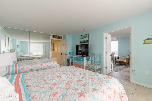 tiled bedroom featuring multiple windows