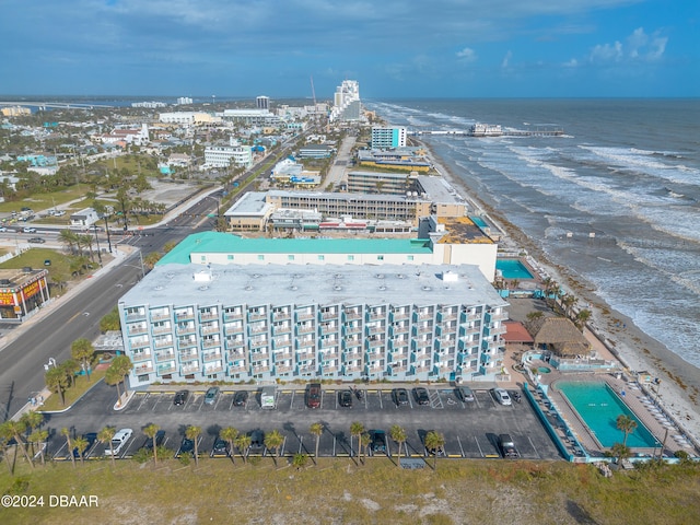 birds eye view of property with a water view and a beach view