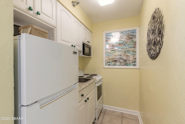 kitchen featuring white cabinetry, light tile patterned flooring, and white appliances