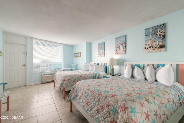 bedroom with a textured ceiling and light tile patterned flooring