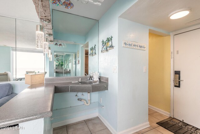 313 S Atlantic Avenue 501 & 503, Daytona Beach, FL 32118 - bathroom featuring tile patterned flooring, a sink, and baseboards