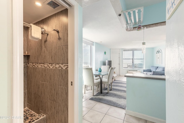 313 S Atlantic Avenue 501 & 503, Daytona Beach, FL 32118 - bathroom with a tile shower, vanity, and tile patterned floors