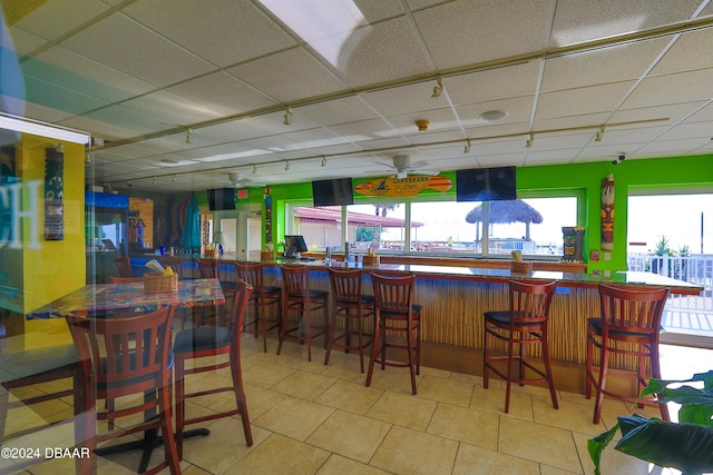 313 S Atlantic Avenue 501 & 503, Daytona Beach, FL 32118 - indoor dry bar with track lighting, plenty of natural light, a drop ceiling, tile patterned flooring, and ceiling fan