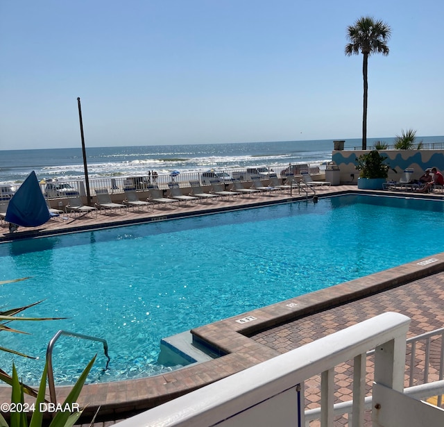 view of pool with a water view