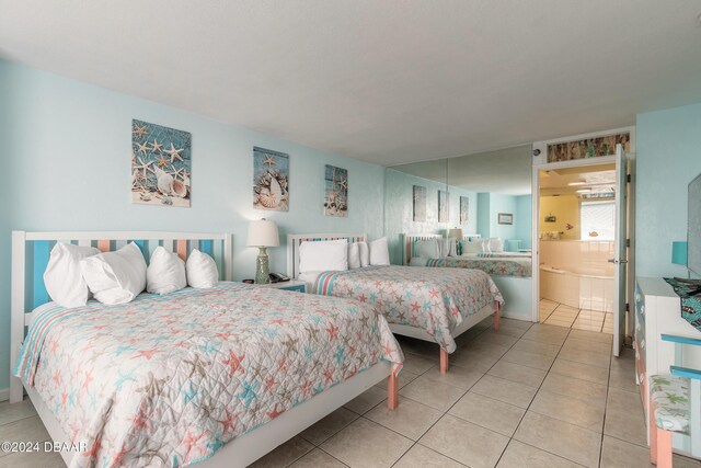 313 S Atlantic Avenue 501 & 503, Daytona Beach, FL 32118 - tiled bedroom featuring ensuite bath and baseboards