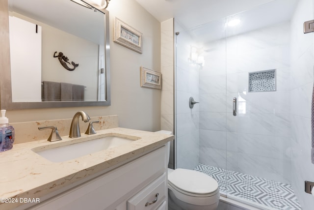 bathroom featuring walk in shower, vanity, and toilet