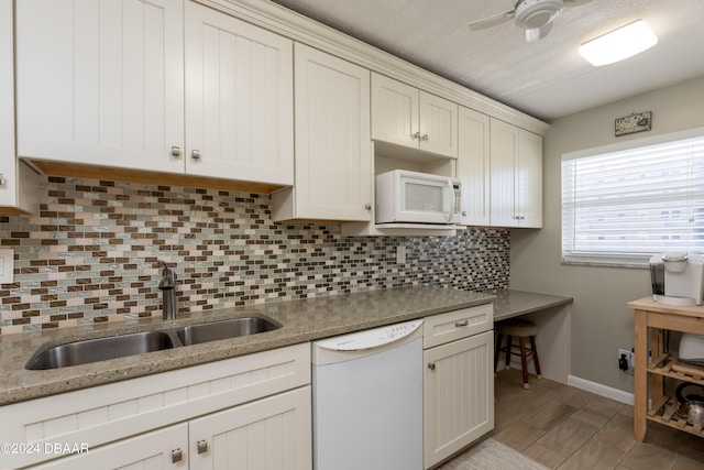 kitchen with light hardwood / wood-style floors, white cabinetry, sink, tasteful backsplash, and white appliances