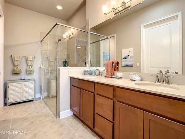 bathroom with vanity, tile patterned floors, and a shower with shower door