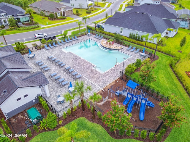 view of swimming pool featuring a playground and a patio area