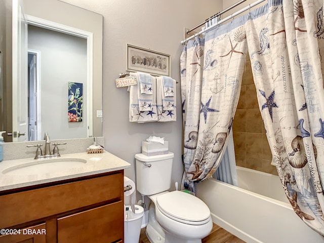 full bathroom with hardwood / wood-style floors, vanity, toilet, and shower / tub combo