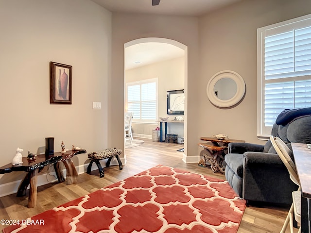 sitting room featuring hardwood / wood-style floors and ceiling fan