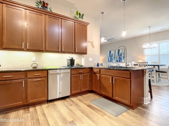 kitchen featuring dishwasher, light hardwood / wood-style flooring, kitchen peninsula, and hanging light fixtures