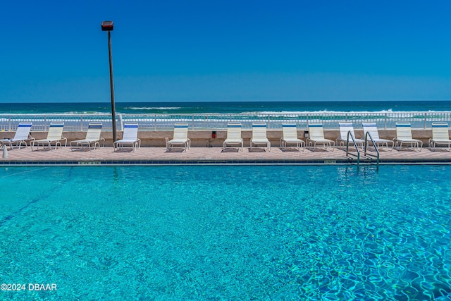 view of pool with a water view