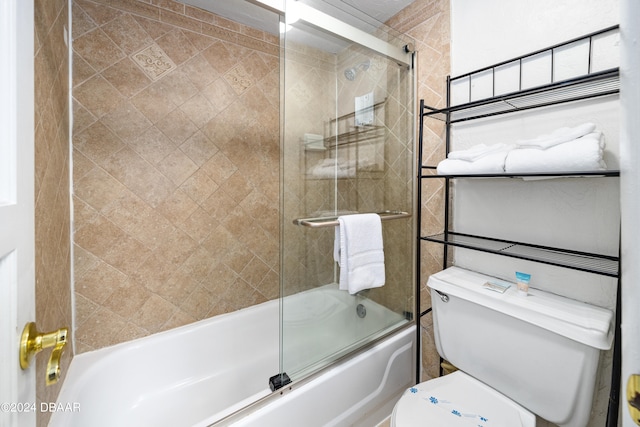 bathroom with shower / bath combination with glass door and toilet