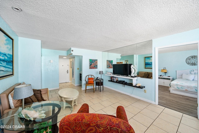 313 S Atlantic Ave Unit 602And 604, Daytona Beach, FL 32118 - living room with light tile patterned floors, a textured ceiling, and baseboards