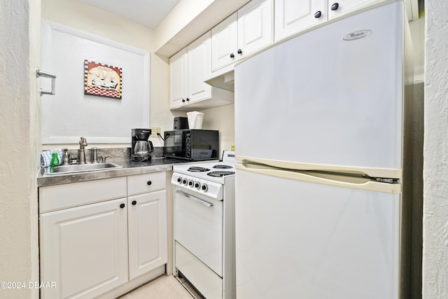 313 S Atlantic Ave Unit 602And 604, Daytona Beach, FL 32118 - kitchen with white appliances, a sink, white cabinets, and stainless steel counters