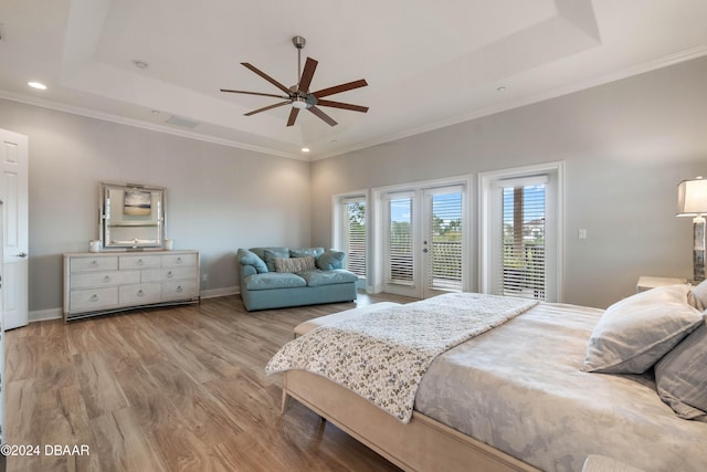 bedroom featuring a raised ceiling, ceiling fan, and access to outside