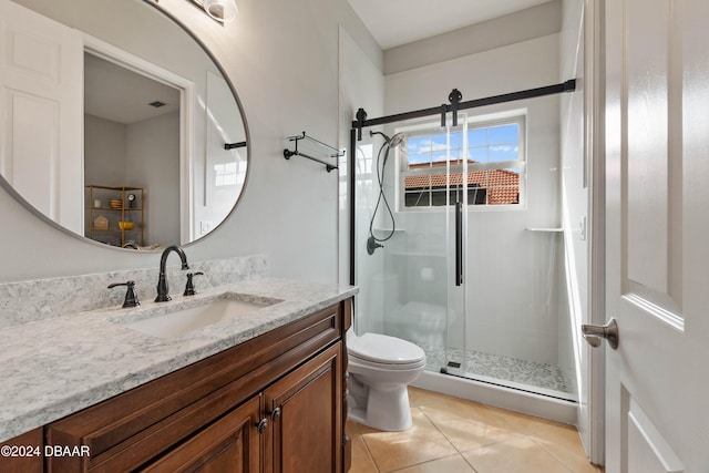 bathroom featuring toilet, vanity, tile patterned floors, and walk in shower