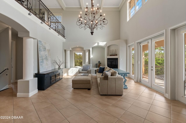 tiled living room with beam ceiling, coffered ceiling, a high ceiling, and a notable chandelier