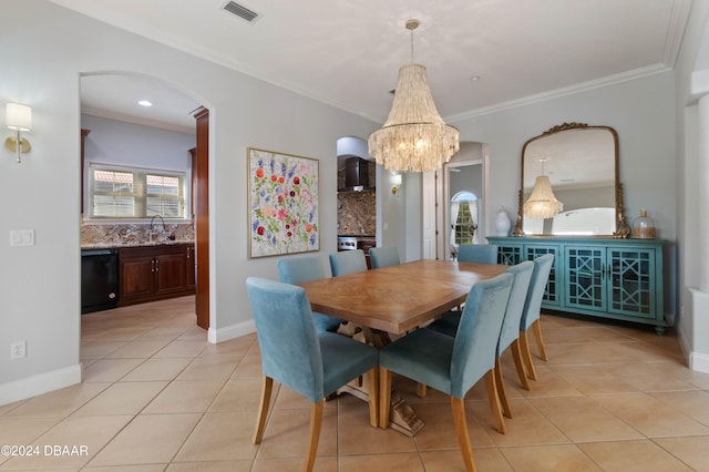 dining space with sink, light tile patterned floors, crown molding, and an inviting chandelier