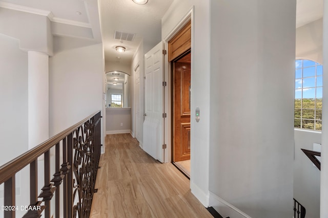 corridor with light wood-type flooring