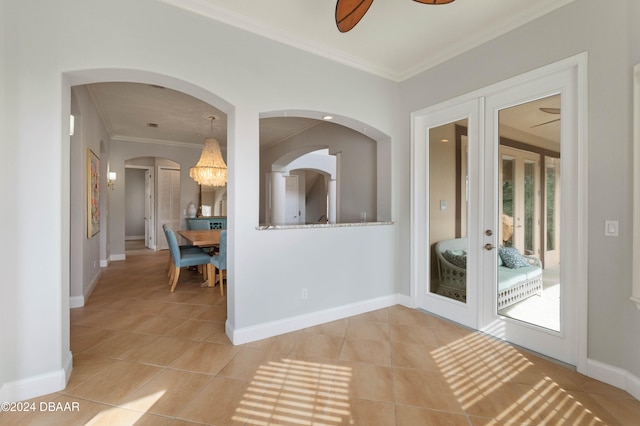 interior space with crown molding, french doors, and light tile patterned flooring