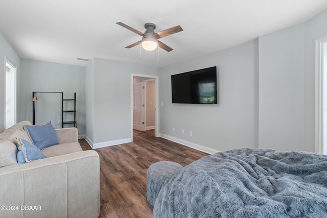 living room featuring ceiling fan and dark wood-type flooring