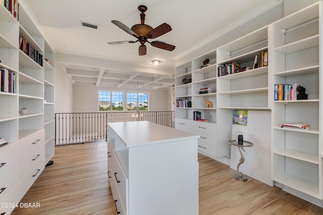 walk in closet with beam ceiling, light hardwood / wood-style flooring, ceiling fan, and coffered ceiling