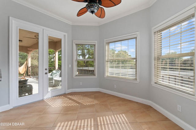 unfurnished sunroom featuring ceiling fan