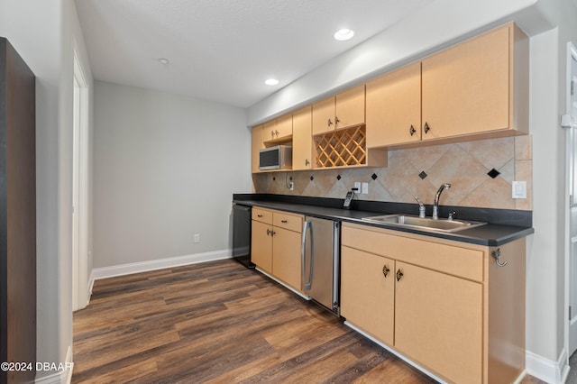 kitchen with light brown cabinetry, tasteful backsplash, dark wood-type flooring, sink, and fridge