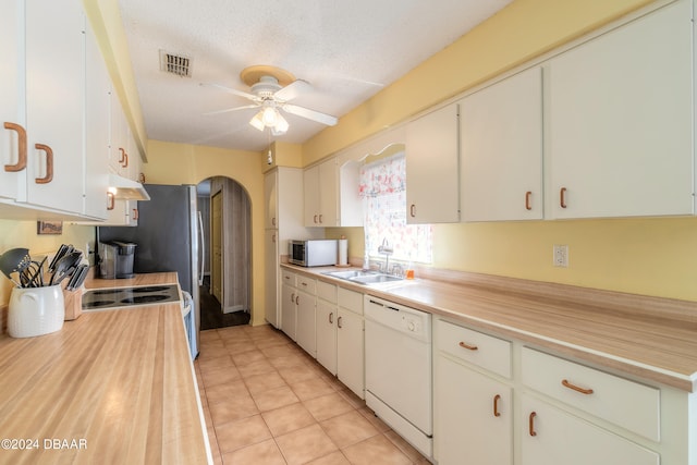 kitchen featuring sink, white cabinetry, a textured ceiling, light tile patterned floors, and dishwasher