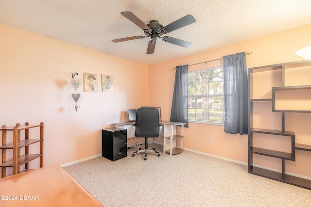 carpeted home office featuring ceiling fan and a textured ceiling