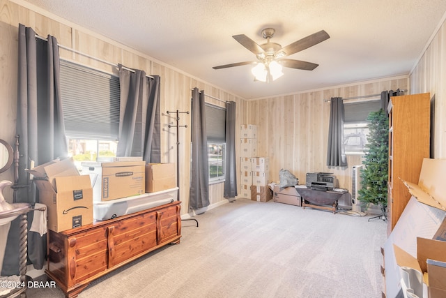 sitting room featuring crown molding, light colored carpet, ceiling fan, and a textured ceiling