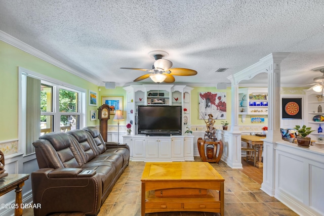 3048 Mango Tree Dr, Edgewater, FL 32141 - living area with ceiling fan, a decorative wall, crown molding, a textured ceiling, and wainscoting