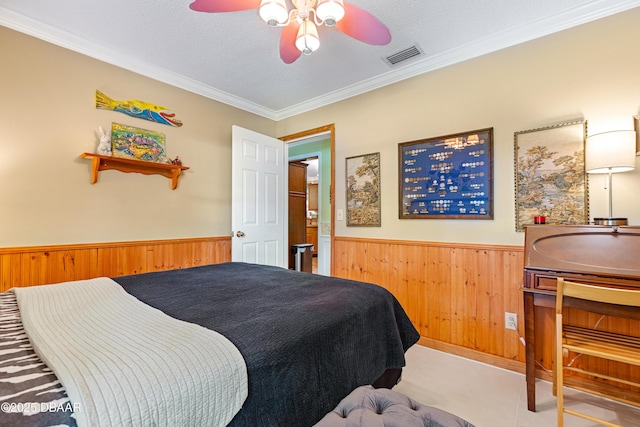 3048 Mango Tree Dr, Edgewater, FL 32141 - bedroom featuring a wainscoted wall, wood walls, crown molding, and ceiling fan