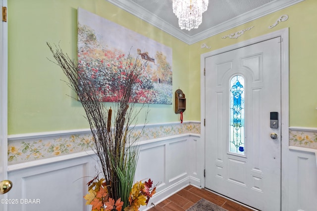 3048 Mango Tree Dr, Edgewater, FL 32141 - foyer entrance featuring a wainscoted wall, a chandelier, dark wood finished floors, and ornamental molding