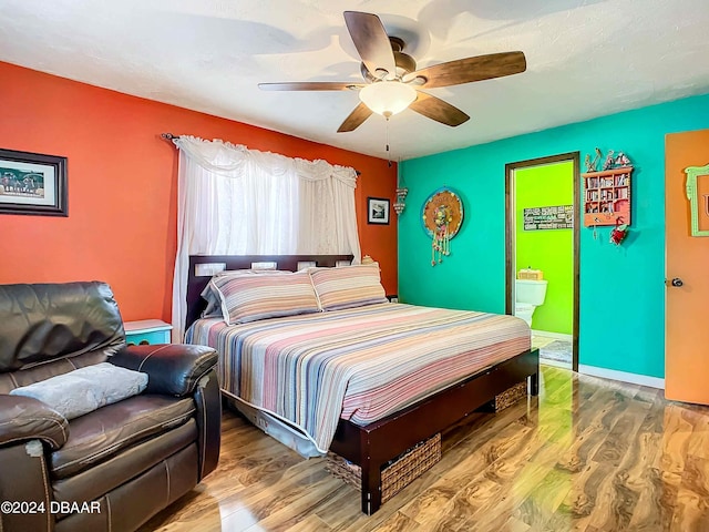 bedroom featuring ensuite bathroom, wood-type flooring, and ceiling fan