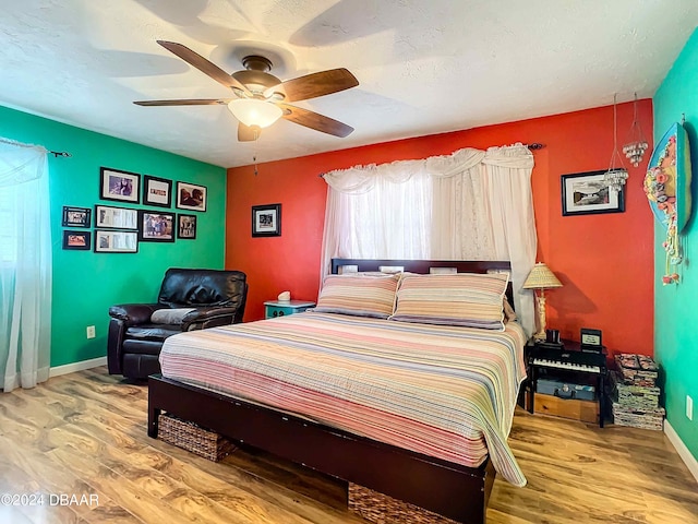 bedroom with ceiling fan and wood-type flooring