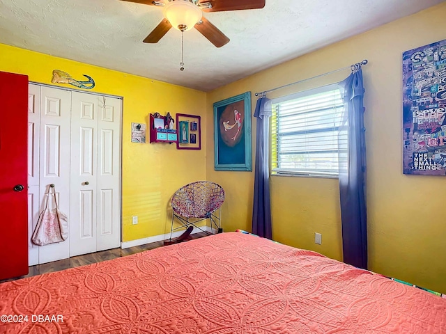 unfurnished bedroom featuring hardwood / wood-style floors, ceiling fan, and a closet