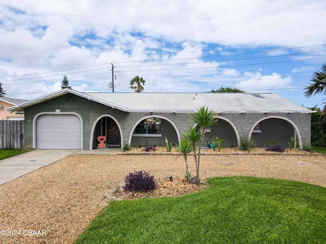 ranch-style house featuring a garage and a front lawn