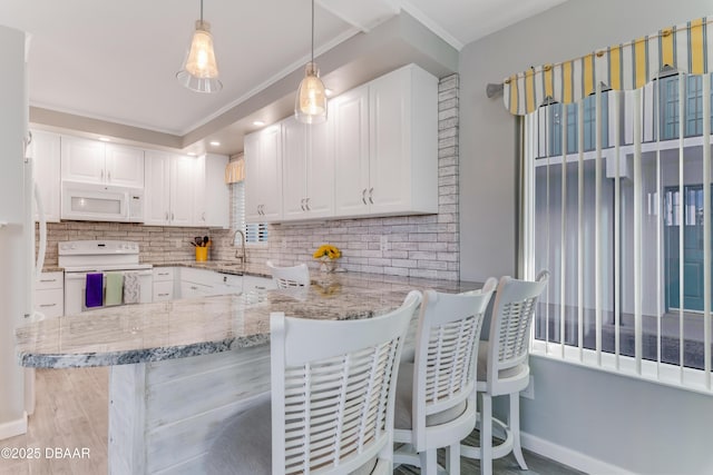 kitchen with white cabinetry, kitchen peninsula, white appliances, decorative backsplash, and pendant lighting