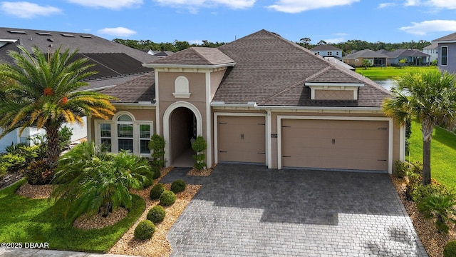 6279 W Fallsgrove Ln, Port Orange, FL 32128 - view of front of property with stucco siding, a garage, decorative driveway, a shingled roof, and a residential view