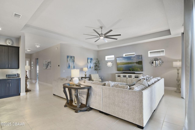6279 W Fallsgrove Ln, Port Orange, FL 32128 - living area featuring a raised ceiling, ceiling fan, and light tile patterned floors