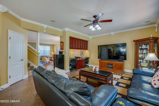 10 Cantilever Ct, Ormond Beach, FL 32174 - living room with ceiling fan, crown molding, stairway, baseboards, and tile patterned floors