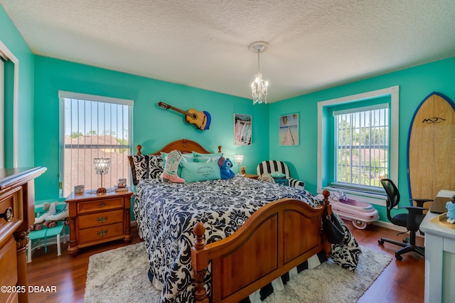 10 Cantilever Ct, Ormond Beach, FL 32174 - bedroom featuring a chandelier, a textured ceiling, and dark wood finished floors